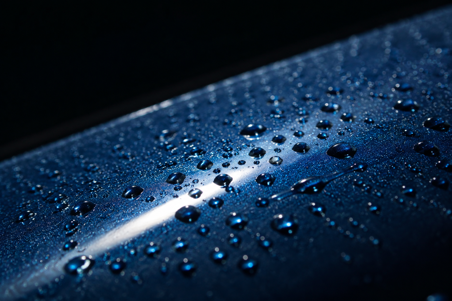 Water beading on blue paint